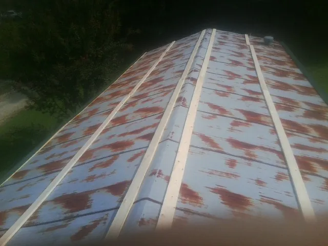 Rusted metal roof panels with new wood purlins before replacement — Storm Damage Roof Repair in Royston by Roofing Brothers