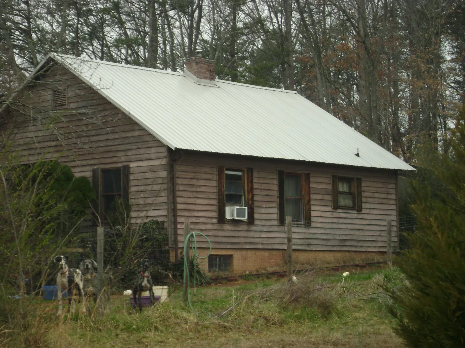 White metal roof on an old wood sided farmhouse, from a Asphalt Shingle Roof Repair job in Royston